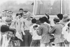 McCain waiting for the rest of the group to leave the bus at airport after being released as a POW